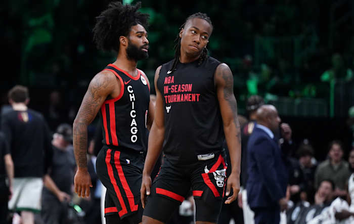  Chicago Bulls guard Ayo Dosunmu (12) and guard Coby White (0) return to the bench during a break in the action against the Boston Celtics in the second half at TD Garden.
